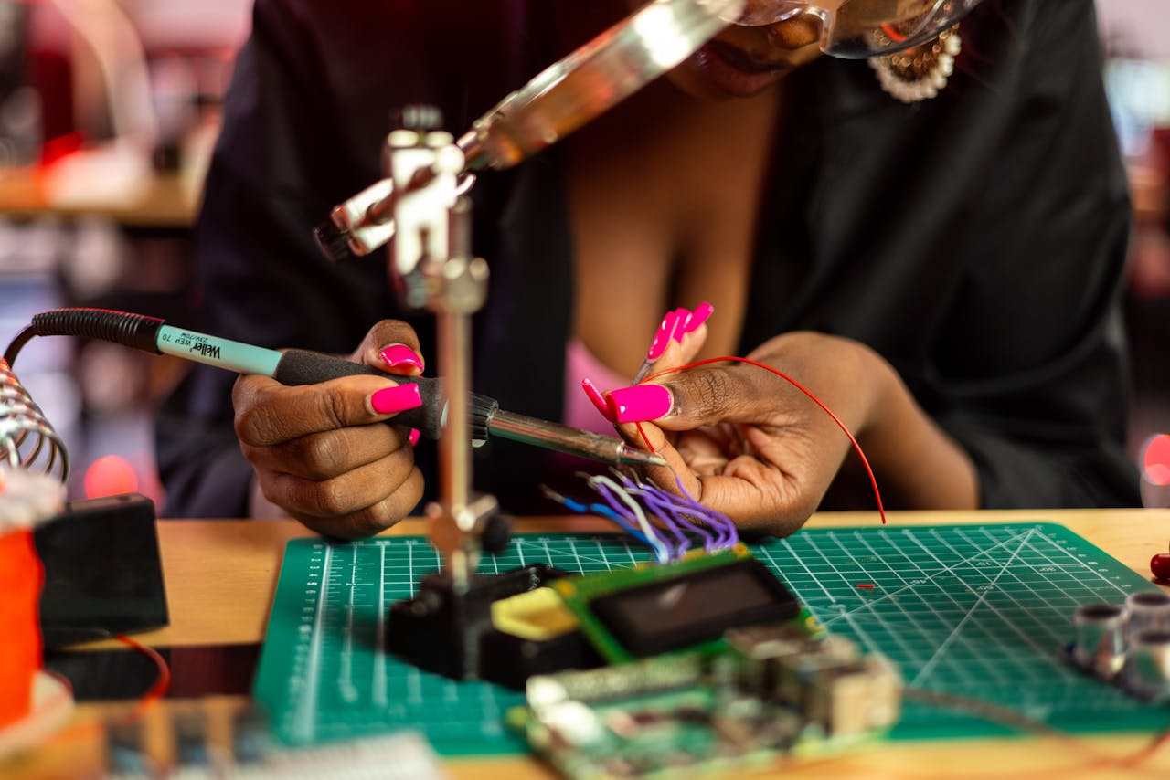 Woman Soldering Wires